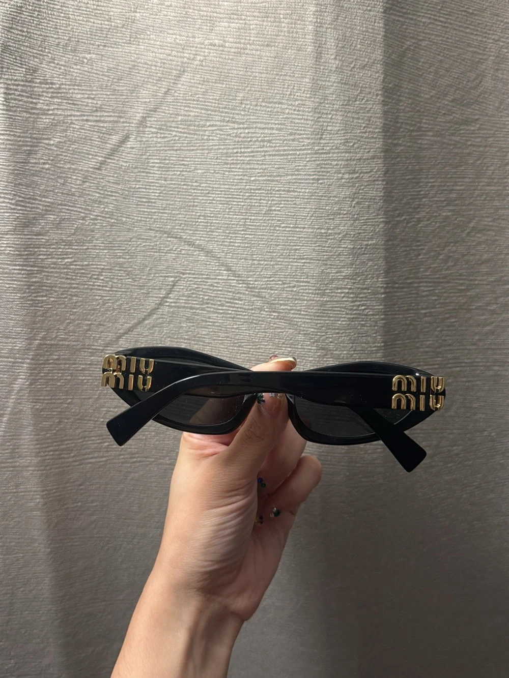 Miu Miu Black Cat-Eye Sunglasses with Gold Logo Accents